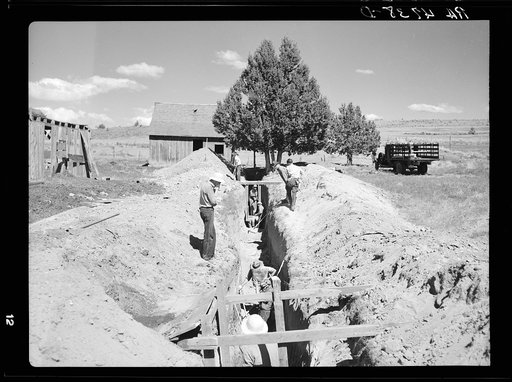 In developing the land purchasing in central Oregon, the Resettlement Administration has attempted to make available every possible source of water. A crew of men are digging out a natural spring