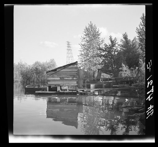 Privy floating in Willamette River. Squatters. Hooverville, Portland, Oregon