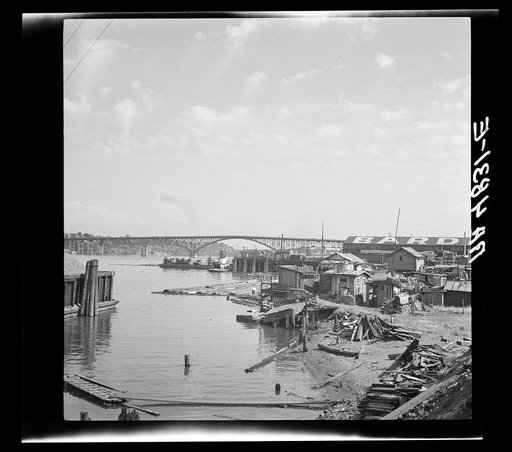 Squatters' shacks along the Willamette River in Portland, Oregon. Many of the men living here during the winter work in the nearby orchards of the Williamette and Yakima Valley in the summer