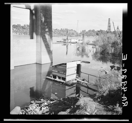 Privy floating in Willamette River. Hooverville, Portland, Oregon