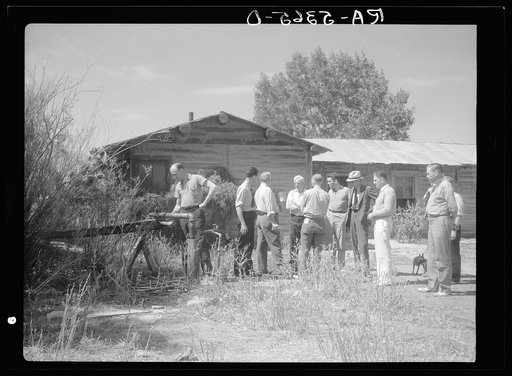Drought committee stops for drink at artesian well on farm near Broadus, Montana