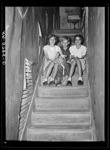 Child of migrant citrus worker who lives in a rundown apartment house. The sink at the head of the stairs is the only running water in the house. Winterhaven, Florida