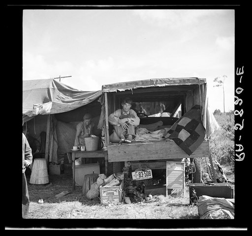 Family from New Mexico, camped near the packinghouse at Deerfield, Florida. Note the box labeled "Yakima apples" which has been carried all the way from the apple orchards of Washington