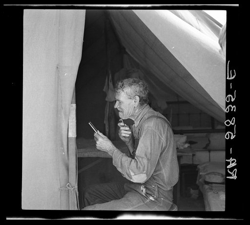A migrant packinghouse worker shaving. Deerfield Florida