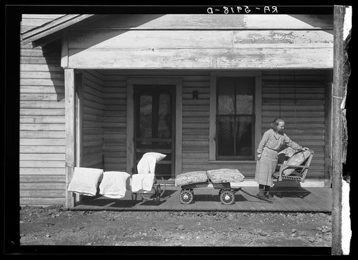 Mrs. Eargle of Fairfield airing her bedding preparatory to moving to her new home at Gardendale, Alabama