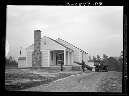Mr. William Howard supervises the men moving his household goods into a new house at Gardendale, Alabama