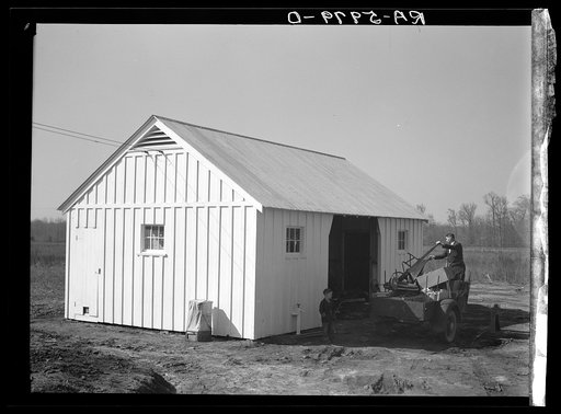 Mr. Cherser unloading some of his farming implements at the barn on his new homestead. Greenwood, Alabama