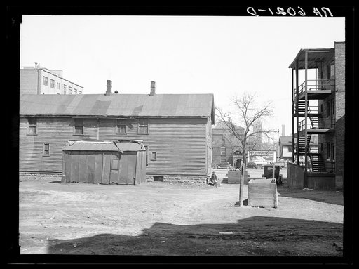 Exterior of house on alley between 7th and 8th and Milbourn and State Streets. Milwaukee, Wisconsin