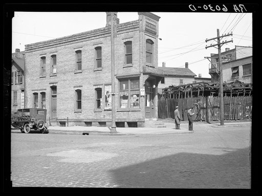 North 10th and McKinley Streets, house next to junk yard. Milwaukee, Wisconsin