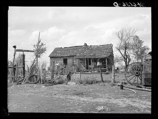 Part of John Cain family who live in this three-room house near Ashland, Missouri. University of Missouri game and arboretum project