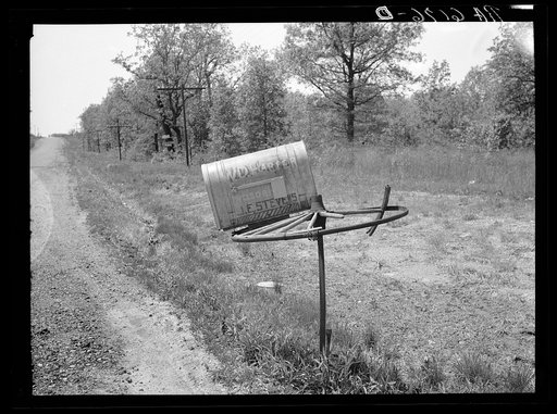 Rural mail box on old wagon wheel. Lake of the Ozarks, Missouri