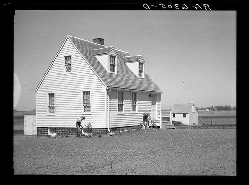 Granger homesteader and son working in flower bed. Iowa