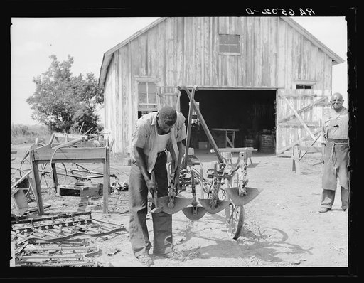 "Gang" cultivating plow being repaired at Sunflower plantation. Sunflower, Mississippi