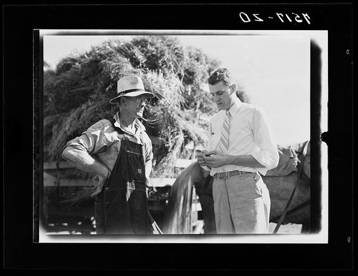 Farm Security Administration representative with Clarence Thornton, Farm Security Administration borrower. Story County, Iowa