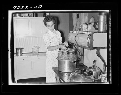 Mrs. Thornton, wife of Farm Security Administration borrower, canning vegetables with pressure cooker. Story County, Iowa