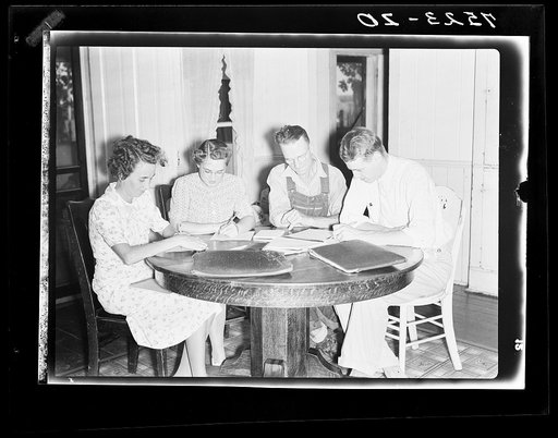 Clarence Thornton and wife, Farm Security Administration borrowers, going over farm plan with Farm Security Administration representatives. Story County, Iowa