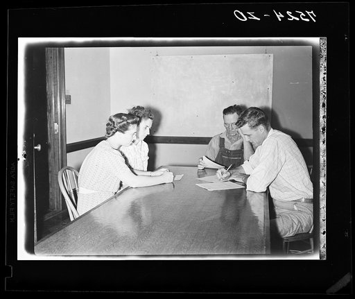 Jack Cowan, Farm Security Administration representative, Helen Warren, home supervisor, and Mr. and Mrs. Clarence Thornton, going over farm and home plans. Story County, Iowa