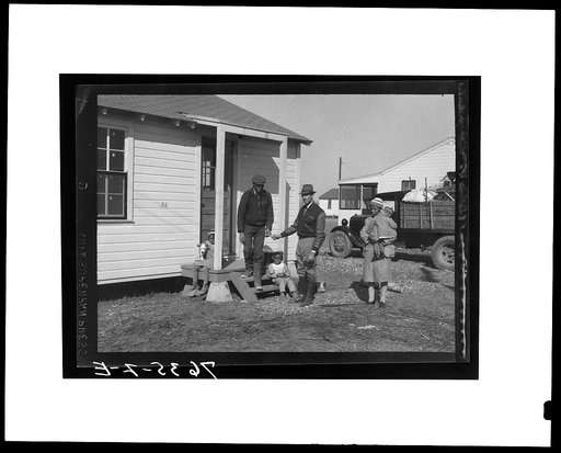 Hugh Edwards, colored assistant camp manager, presents key to new home to Hunter family. Southeast Missouri