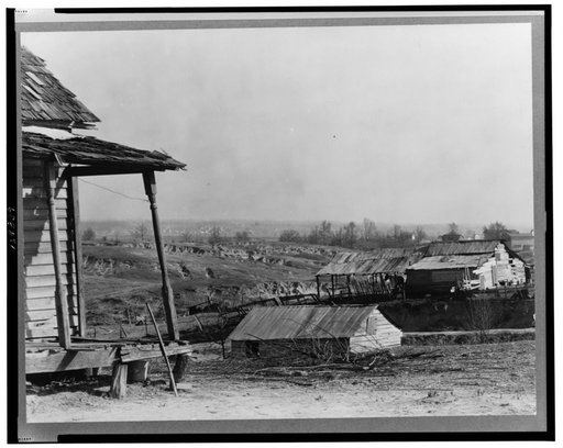 New outskirts of town, showing Negro houses and soil erosion. Tupelo, Mississippi