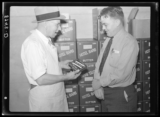 Manager of co-op creamery talking with Farm Security Administration county supervisor. Baldwin City, Kansas