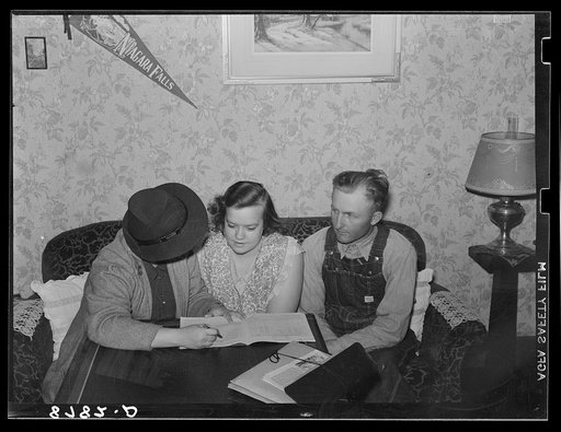 Farm Security Administration home supervisor examining account book of rehabilitation clients. Otoe County, Nebraska