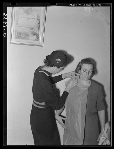Farm Security Administration home supervisor fitting a pattern for rehabilitation client. Nemaha County, Nebraska
