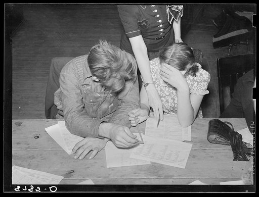 Home supervisor helping young farm couple work out home plan. Group meeting, York, Nebraska