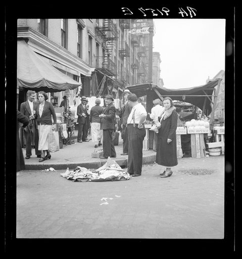 Background photo for Hightstown project. Sixth Street and Avenue C, New York City, where the Solomon family do their shopping. In the street and displayed on newspaper. All socks for sale at ten cents the pair