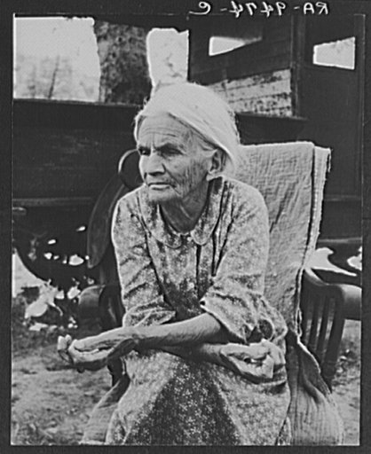 Mother of family camped near a creek bed, panning for gold. "Slept in a bed all my life long till now--sleeping on the ground." Near Redding, California