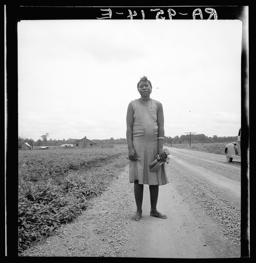 Negro woman carrying her shoes home from church. Mississippi Delta