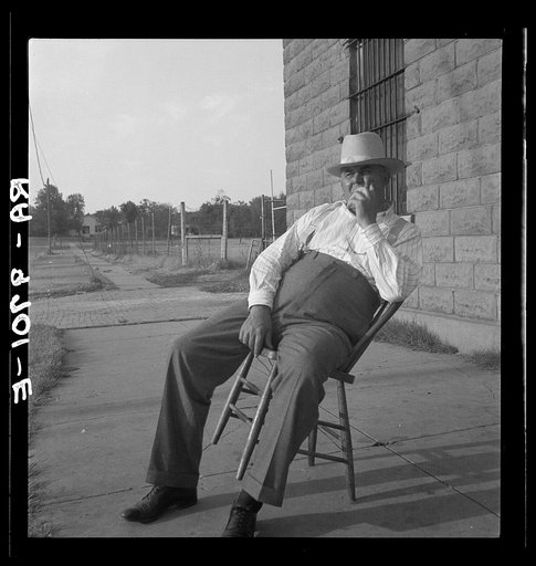 The sheriff of McAlester, Oklahoma, sitting in front of the jail. He has been sheriff for thirty years