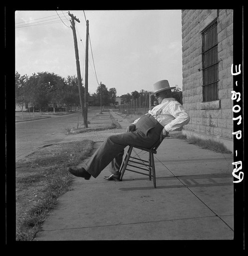 The sheriff of McAlester, Oklahoma, sitting in front of the jail. He has been sheriff for thirty years