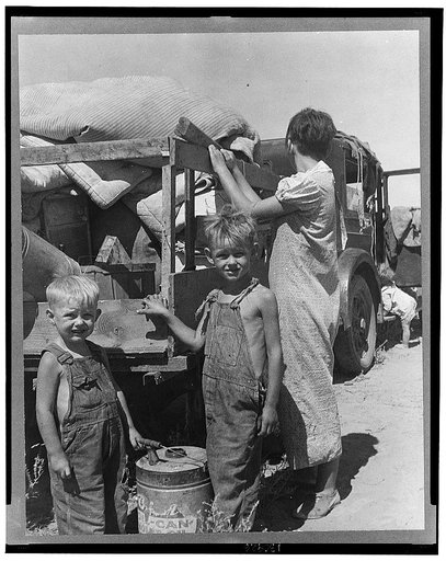 Part of an impoverished family of nine on a New Mexico highway. Depression refugees from Iowa. Left Iowa in 1932 because of father's ill health. Father an auto mechanic laborer, painter by trade, tubercular. Family has been on relief in Arizona but refused entry on relief roles in Iowa to which stat