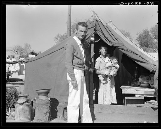 Tom Collins, manager of Kern migrant camp, California, with migrant mother and child