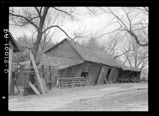 Tool and machine shed on W.H. Cox farm, Clearcreek Township, Johnson County, Iowa. Note how the buildings are propped up. This is an owner-operated farm of one hundred twenty-four acres, sixty of which are tillable
