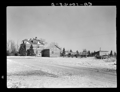 Rustan brothers' farm near Dickens, Iowa. Two hundred forty acres, crop share lease, owned by loan company. Title not clear, but loan company collects the rent and makes a few repairs. This farm was formerly owner-operated until five or six years ago (note equipment standing in open)