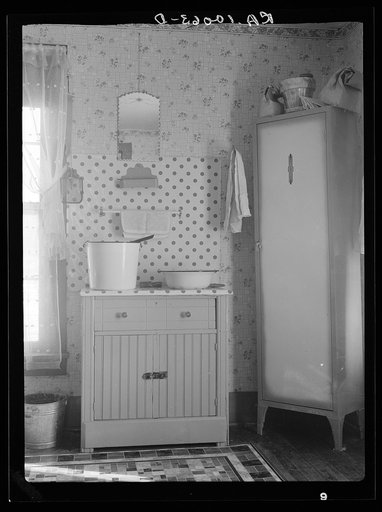 Washstand in house occupied by married hired hand and his wife. Harry Madsen farm near Dickens, Iowa. Three hundred sixty acres, owner-operated