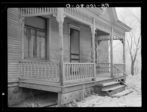 Front porch of house on Elmer Nelson farm. This farm has been in hands of loan company for at least fifteen years. Buildings have not been painted for fifteen years. Crop share lease. Farm full of cockleburrs