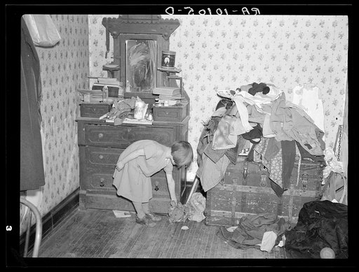 Corner of a bedroom on Edgar Allen farm near Milford, Iowa. There are piles of clothes and rags all over the house. An extreme case of poverty in northwestern Iowa. They are receiving aid from Resettlement Administration