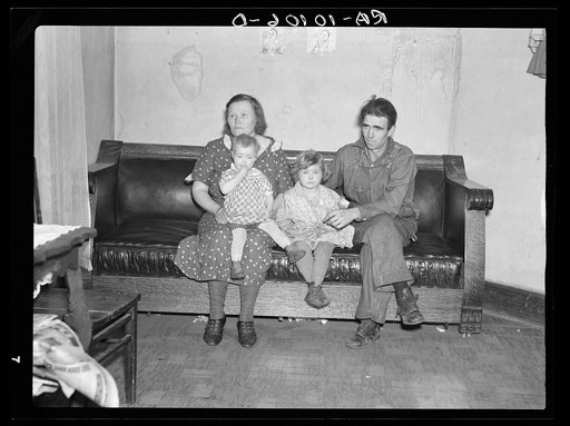 Paul Rauhauser, thirty-eight, with his wife and two of their seven children. Living in Ruthven, Iowa