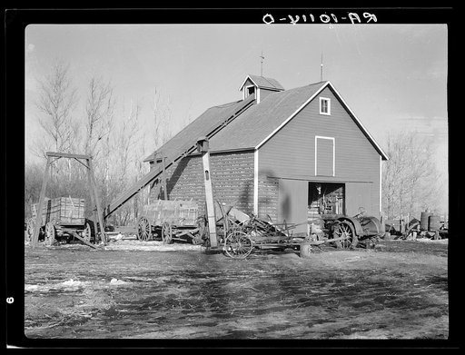 Corn crib on owner-operated farm of G.H. West near Estherville, Iowa. Note wealth of equipment