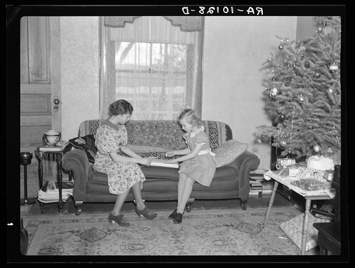 Children of H.H. Tripp wrapping presents for Christmas. Near Dickens, Iowa. Tripp operates his mother's farm