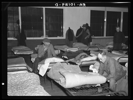 Men's dormitory at night at the homeless men's bureau, Sioux City, Iowa (for unattached men). Unemployment is the primary cause of their being here. This unemployment has been the direct cause of broken homes, through divorce and incompatibility. Most of the men are willing to work if they could fin