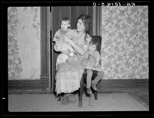 Mrs. Alfred Atkinson with baby and young child in farm home near Shannon City, Iowa. They rent eighty acres from an estate
