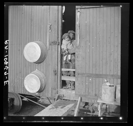 Colored flood refugees at the door of their boxcar home near Cache, Illinois