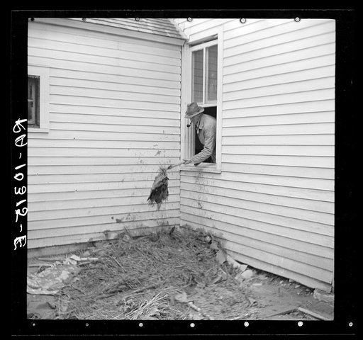 Cleaning flood debris out of a farmhouse. Posey County, Indiana