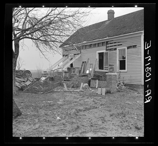 Furniture and debris scattered in Indiana farmyard after flood. Posey County, Indiana
