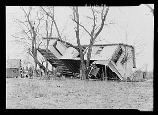 Upturned farmhouse resting against a tree. Result of the flood in Posey County, Indiana