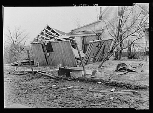 Shattered outbuilding and debris in an Indiana farmyard. 1937 flood