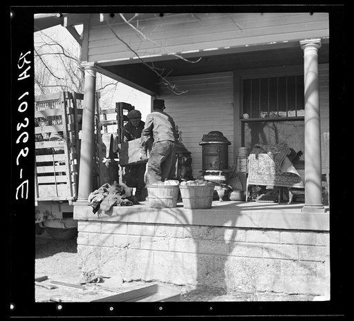 Removing furniture from truck during moving operations of Everett Shoemaker, tenant farmer. Near Shadeland, Indiana